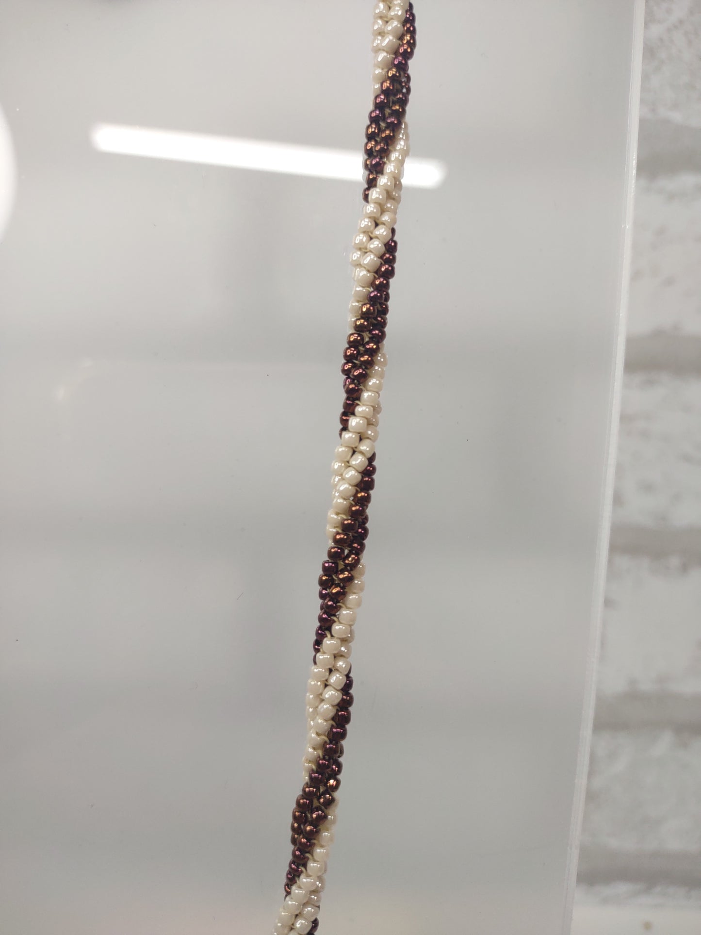 ivory and bronze twisted beaded herringbone necklace with stainless steel toggle clasp - close up of beading