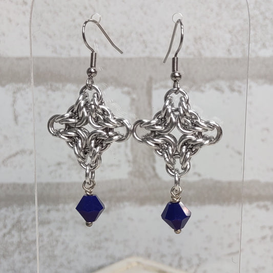 Diamond shaped byzantine chainmail earrings with a navy blue bicone drop bead close up