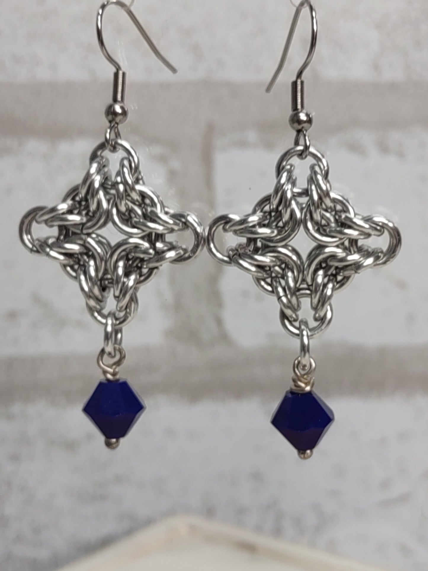 Diamond shaped byzantine chainmail earrings with a navy blue bicone drop bead