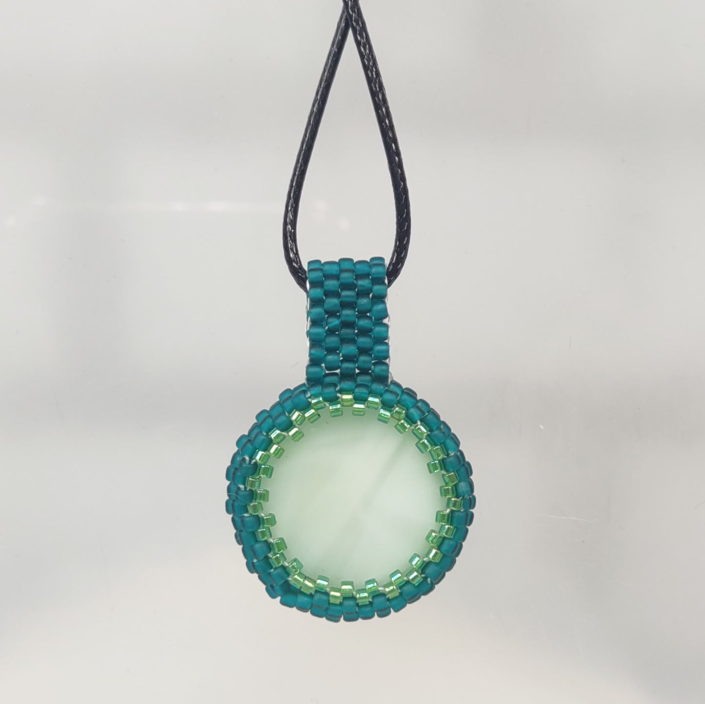 back view green cab pendant with teal beading